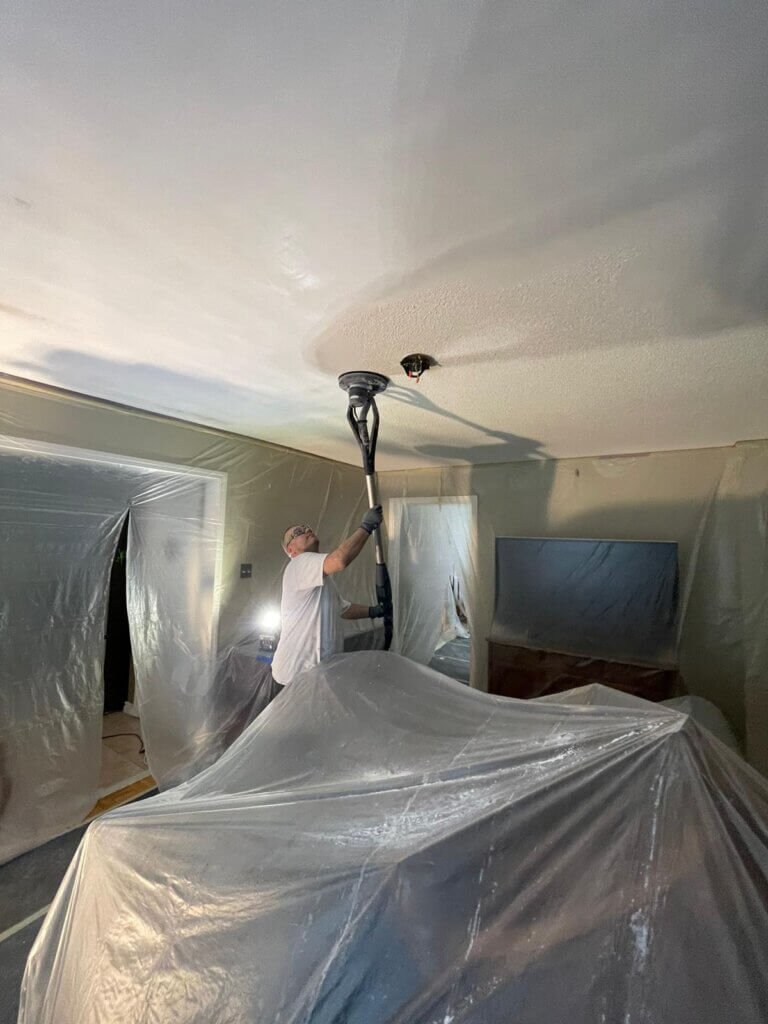 Popcorn ceiling removal being done by an expert from MS Painting with latest tools