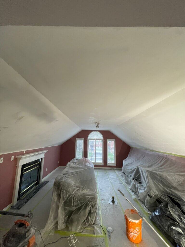 house ceiling before popcorn ceiling removal with furniture covered